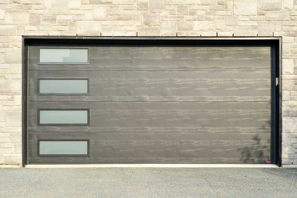 Dark gray double garage door on a residence Southlake, TX